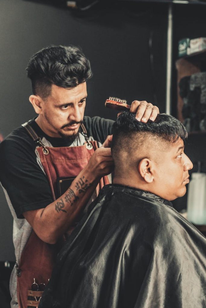 A skilled barber styling a clients hair in a trendy barbershop. Perfect for lifestyle and fashion imagery.