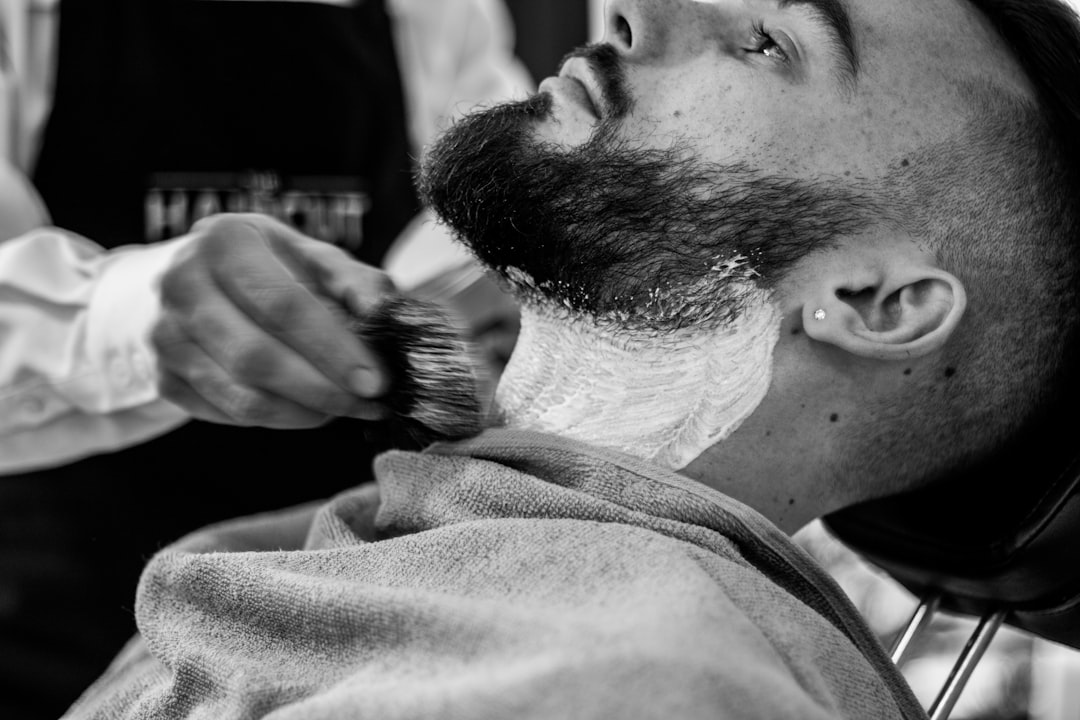 grayscale-photo-of-man-shaving-his-beard-twd3yaqa2nm